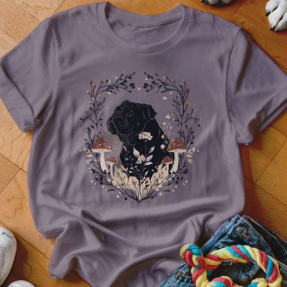 A purple short-sleeved t-shirt features a black dog silhouette inside a botanical mushroom wreath.