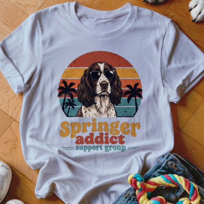 White t-shirt with a retro-style graphic of an English Springer Spaniel wearing sunglasses against a sunset.