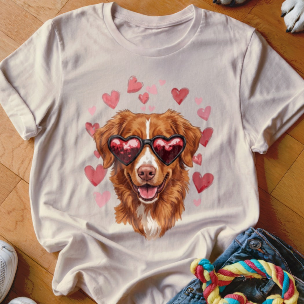 Light-colored t-shirt featuring a golden retriever wearing heart-shaped sunglasses, surrounded by floating pink hearts.