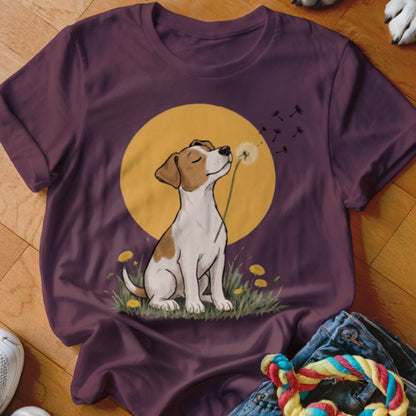 A purple t-shirt featuring an illustration of a dog blowing dandelion seeds against a yellow sun.