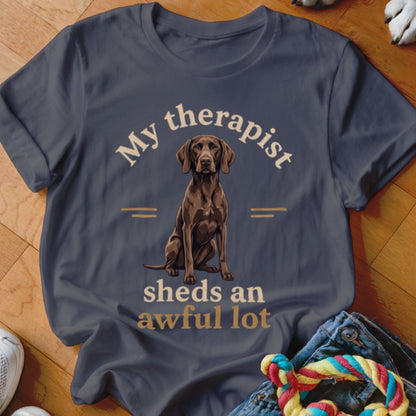 Dark grey t-shirt with a brown dog illustration and text "My therapist sheds an awful lot".