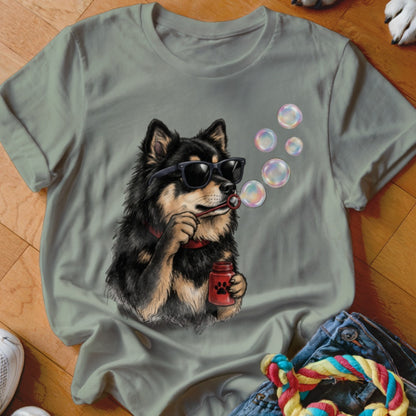 An olive green t-shirt features a graphic of a black and tan dog wearing sunglasses and blowing bubbles.