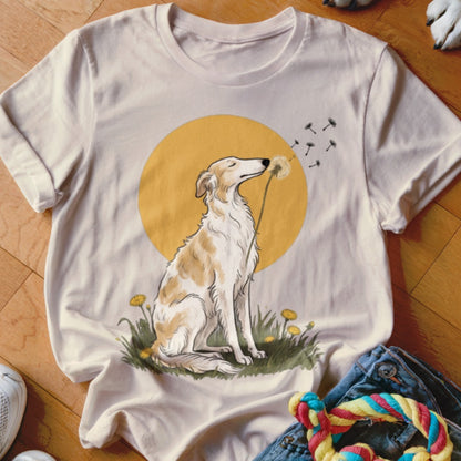 A light-colored t-shirt featuring a graphic of a seated dog sniffing a dandelion against a yellow circle.