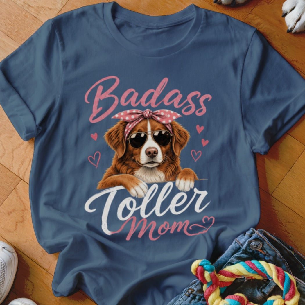 Blue t-shirt with a dog wearing sunglasses and a bandana, reading "Badass Toller Mom".