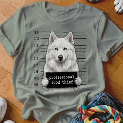 White husky mugshot with "professional food thief" sign.