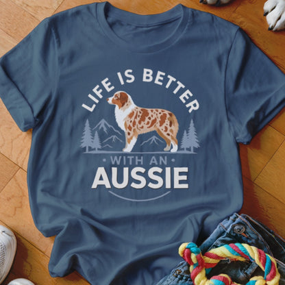 Dark blue t-shirt featuring a graphic of an Australian Shepherd, mountain scenery, and the text Life Is Better With An Aussie.