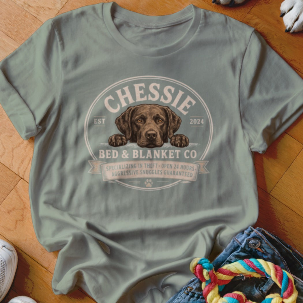Green t-shirt with Chessie dog and Bed & Blanket Co. logo.