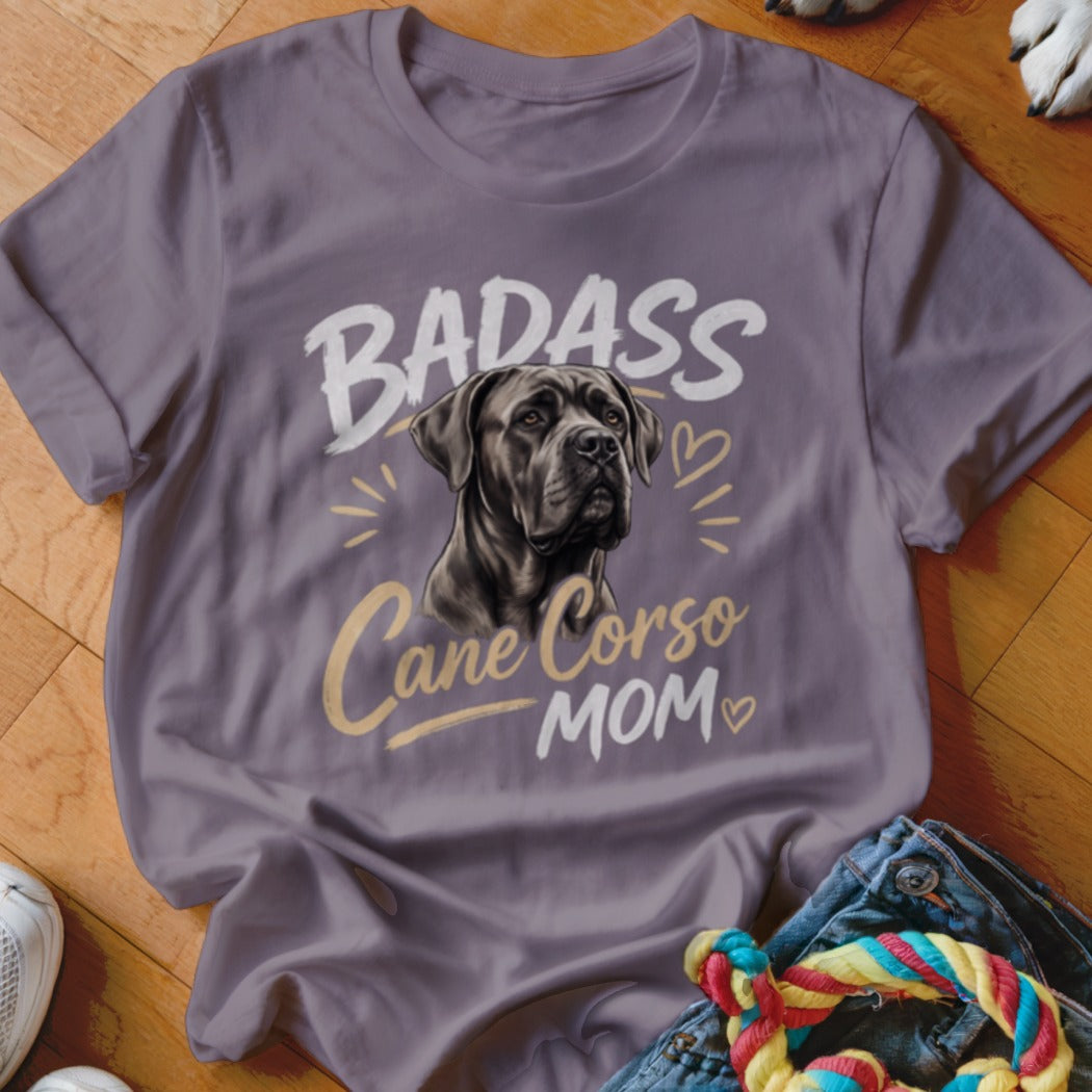 A grey t-shirt featuring an illustration of a Cane Corso and the text Badass Cane Corso Mom.