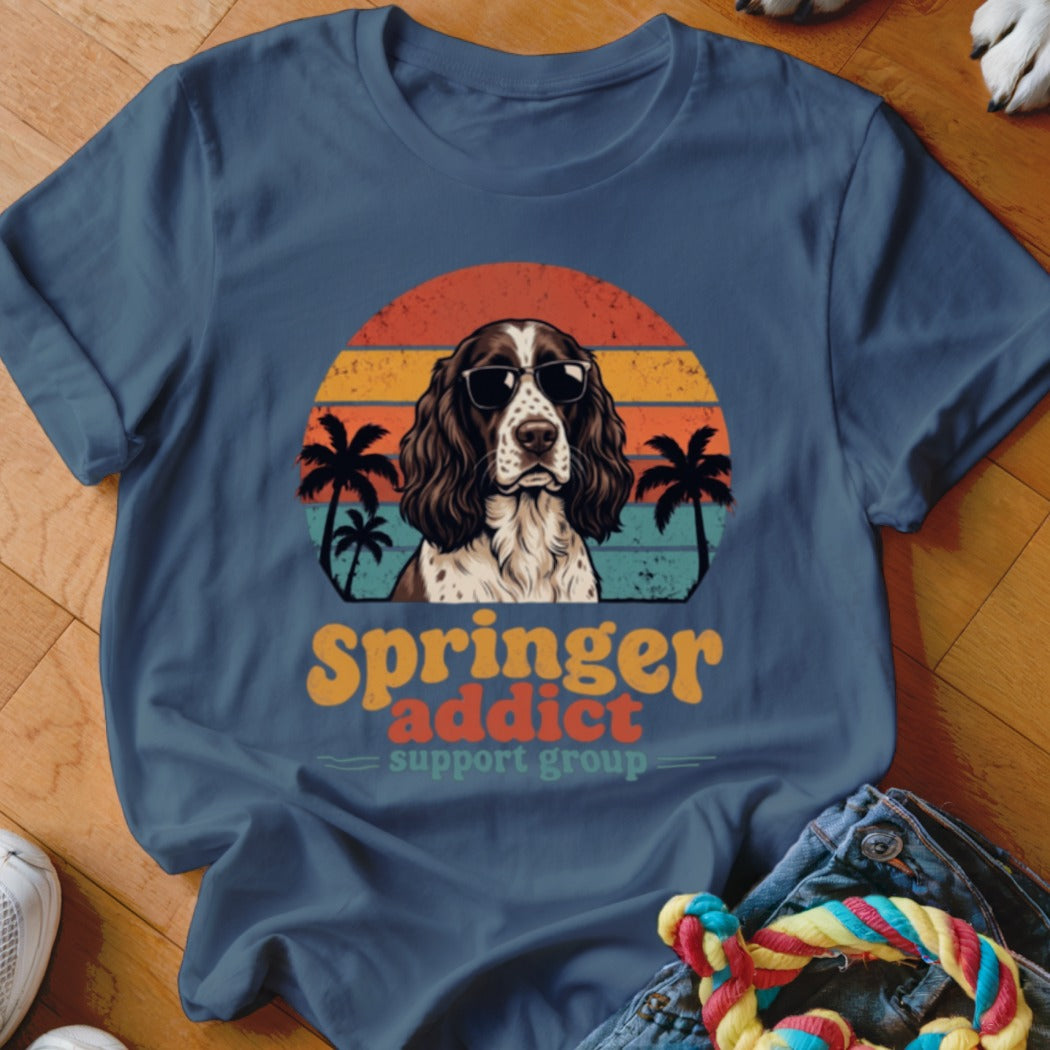 Blue crewneck t-shirt featuring a retro graphic of an English Springer Spaniel wearing sunglasses with palm trees and sunset stripes.