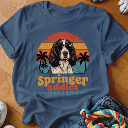 Blue crewneck t-shirt featuring a retro graphic of an English Springer Spaniel wearing sunglasses with palm trees and sunset stripes.