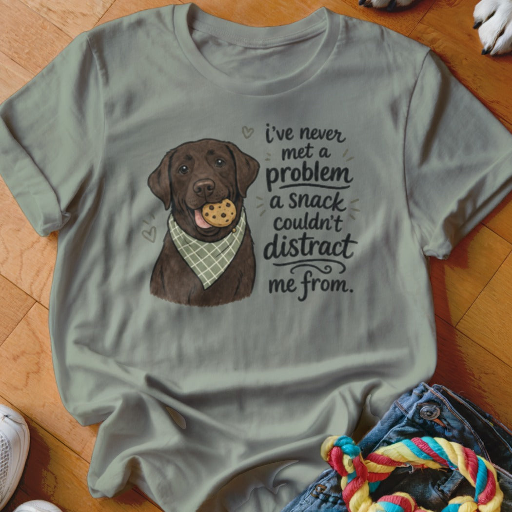 Chocolate lab wearing bandana and cookie with text: "I've never met a problem a snack couldn't distract me from."