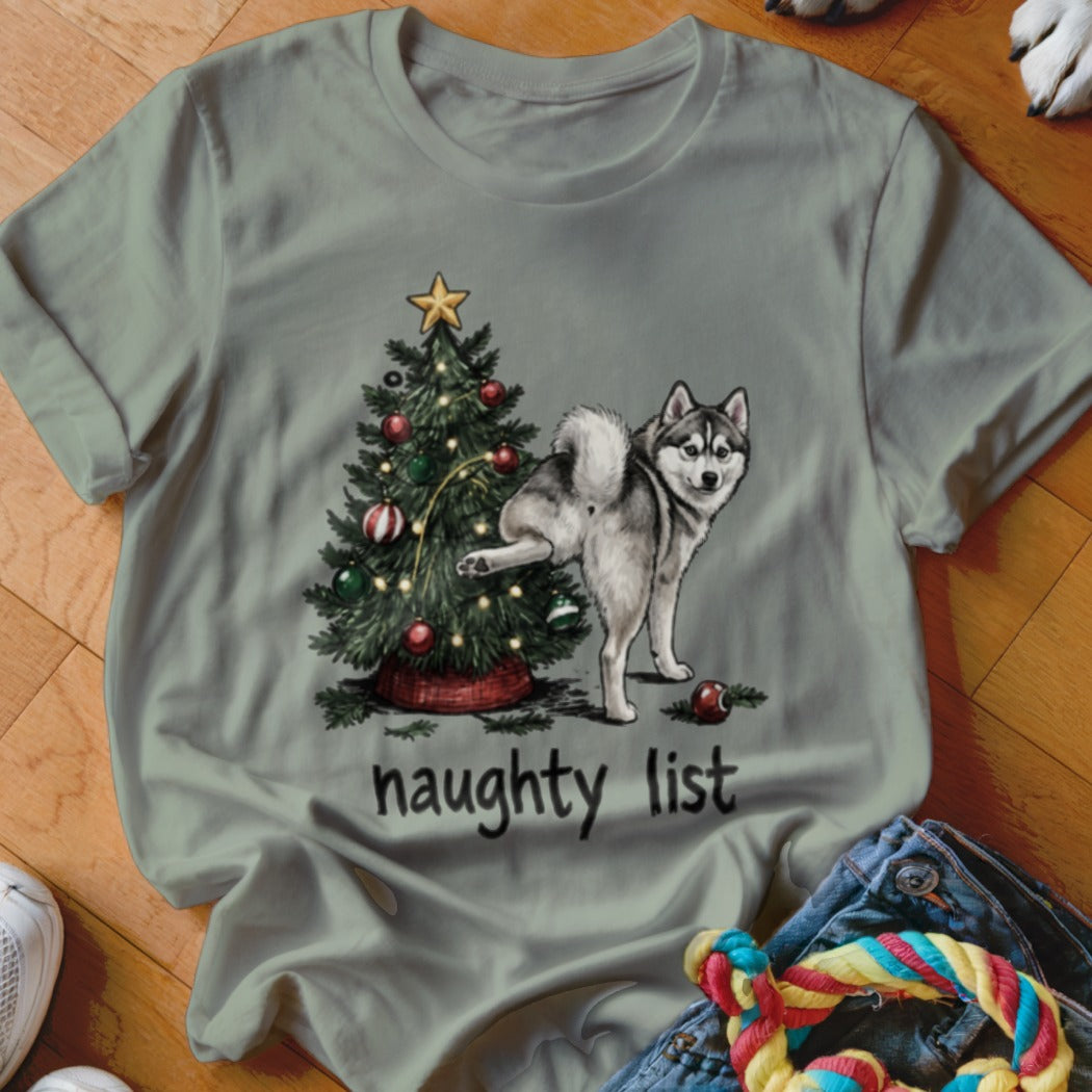 Husky near Christmas tree with text "naughty list"