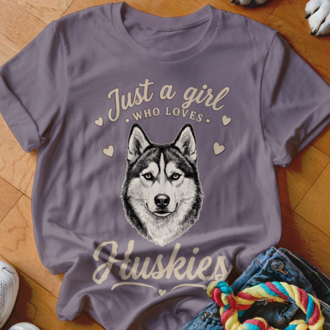 A purple t-shirt featuring a husky graphic and the text Just a girl who loves Huskies.