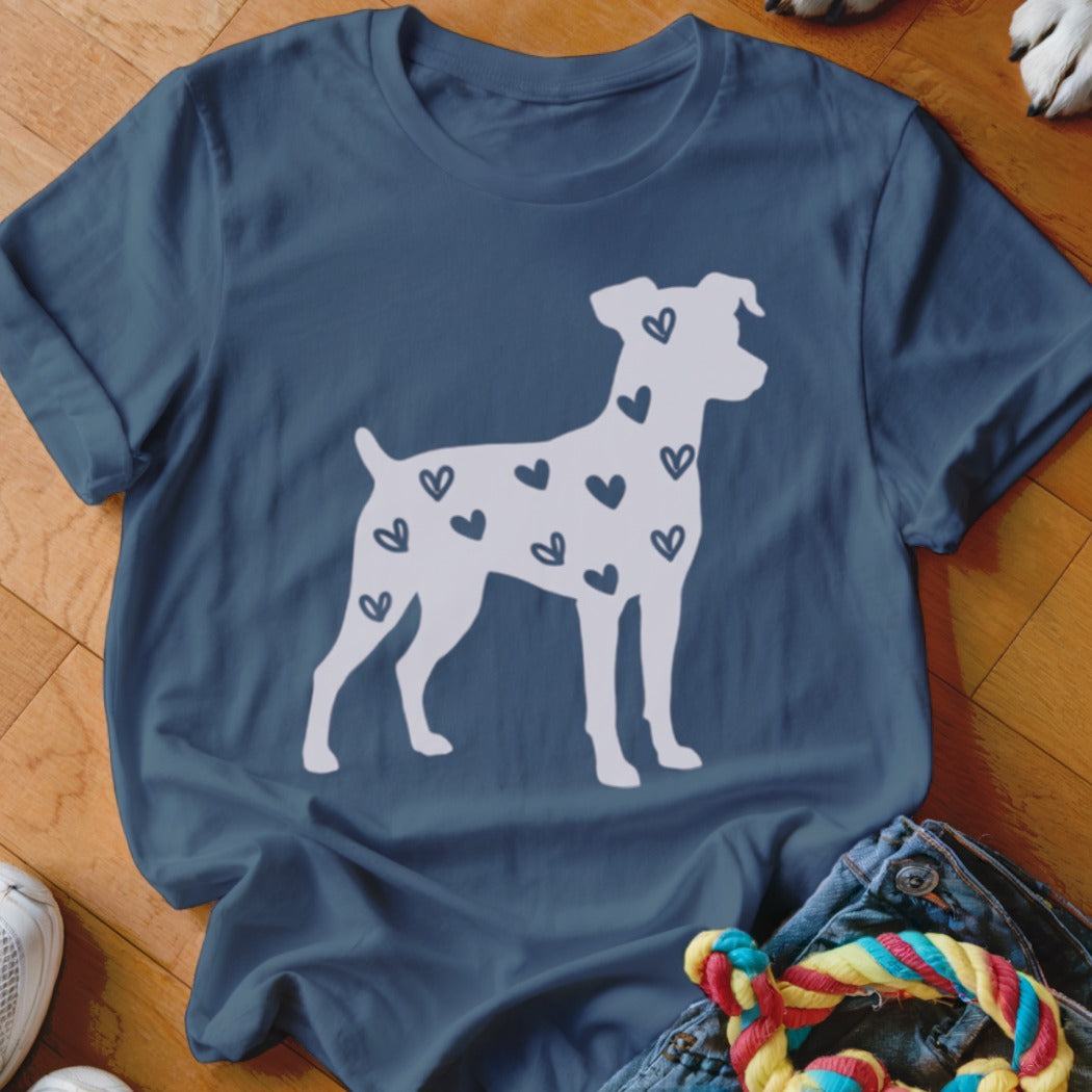 White dog silhouette filled with small dark hearts on a blue t-shirt.