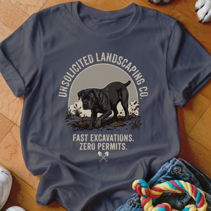 Dark t-shirt with graphic of a black dog, "Unsolicited Landscaping Co." and "Fast Excavations. Zero Permits."