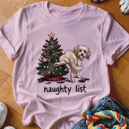 Pink t-shirt with a dog lifting its leg on a Christmas tree with the words "naughty list".
