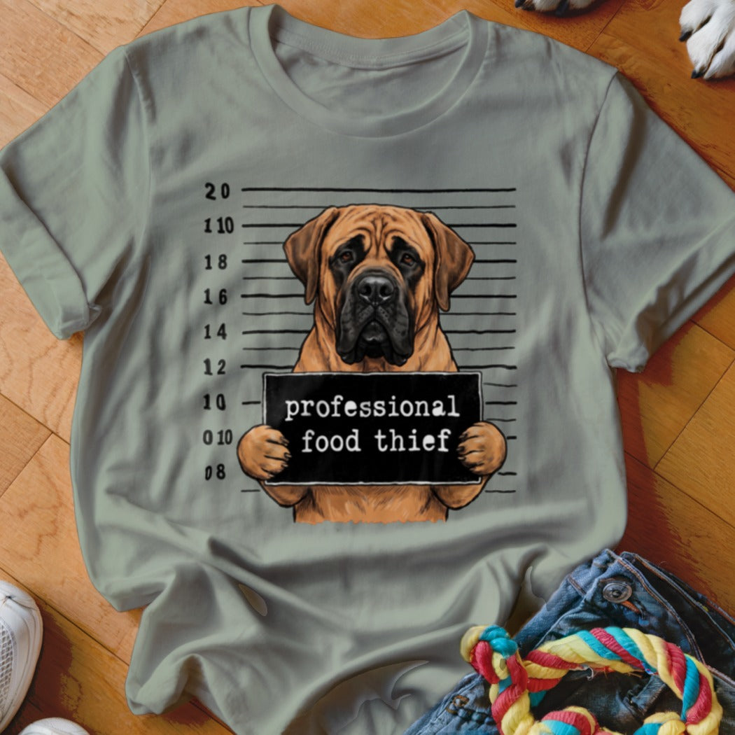 Mastiff dog mugshot with sign reading "professional food thief".