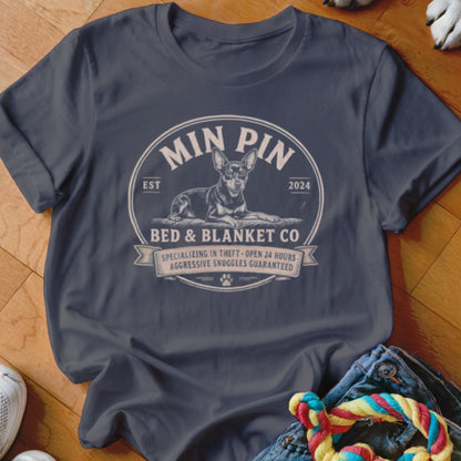 Min Pin Bed & Blanket Co. t-shirt featuring a dog graphic and text.