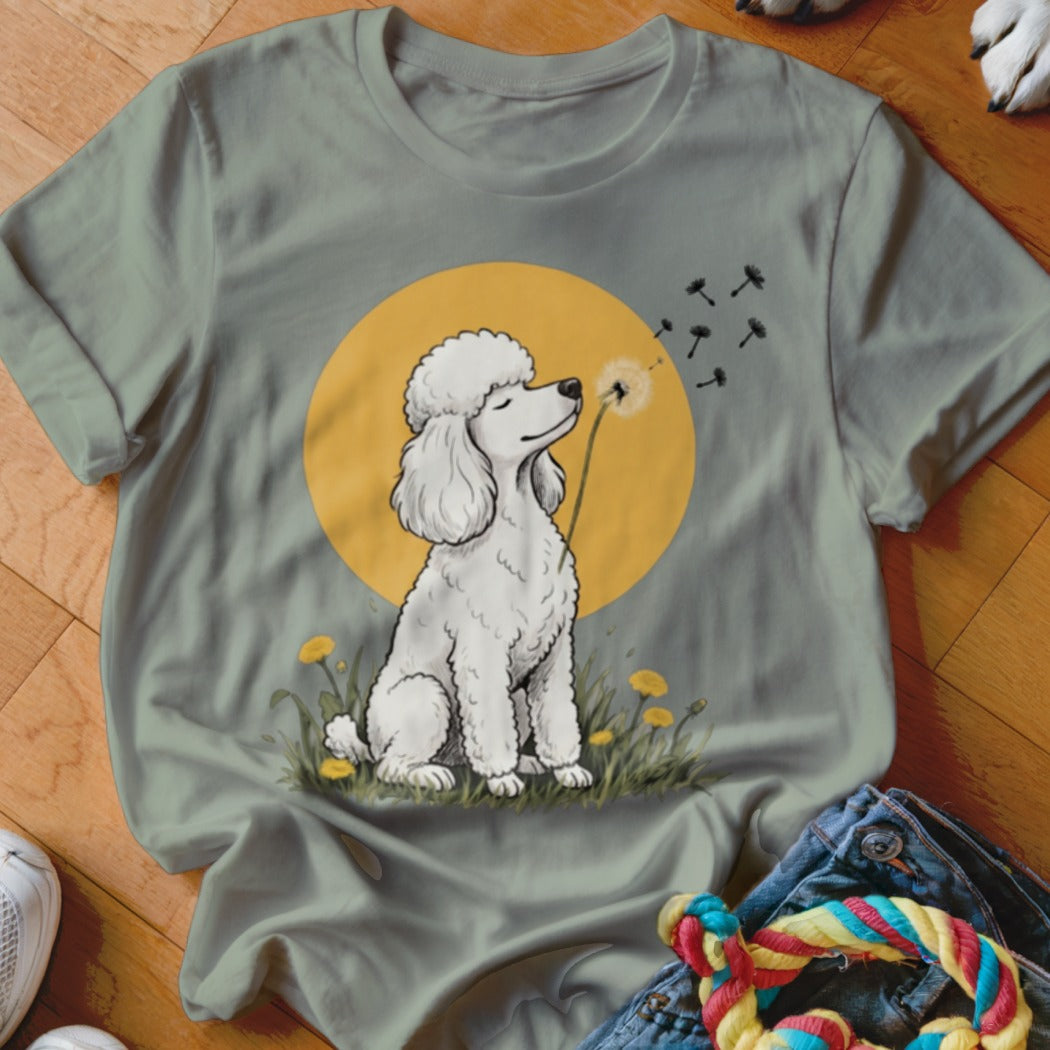 Sage green crewneck t-shirt featuring a graphic of a white poodle sniffing dandelions against a yellow moon.