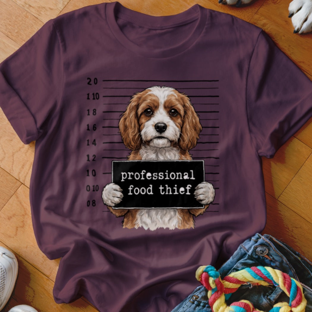 Dog mugshot with sign reading "professional food thief"