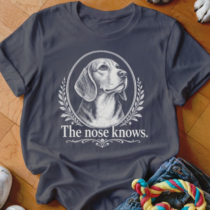 Dark grey t-shirt with a beagle portrait in an oval frame and the text "The nose knows."