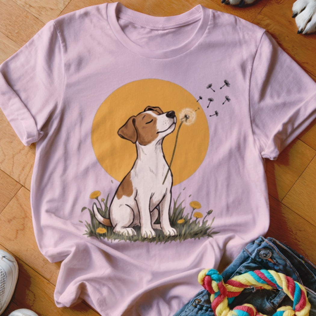 A light pink t-shirt features a graphic of a Jack Russell terrier blowing dandelion seeds.