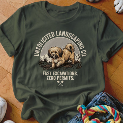 Green t-shirt with a cartoon dog digging, "Unsolicited Landscaping Co." and "Fast Excavations. Zero Permits." text.