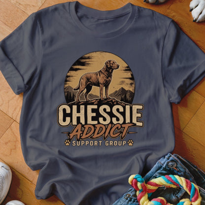 Dark gray crewneck t-shirt featuring a retro graphic of a Chesapeake Bay Retriever, mountains, and the text Chessie Addict Support Group.