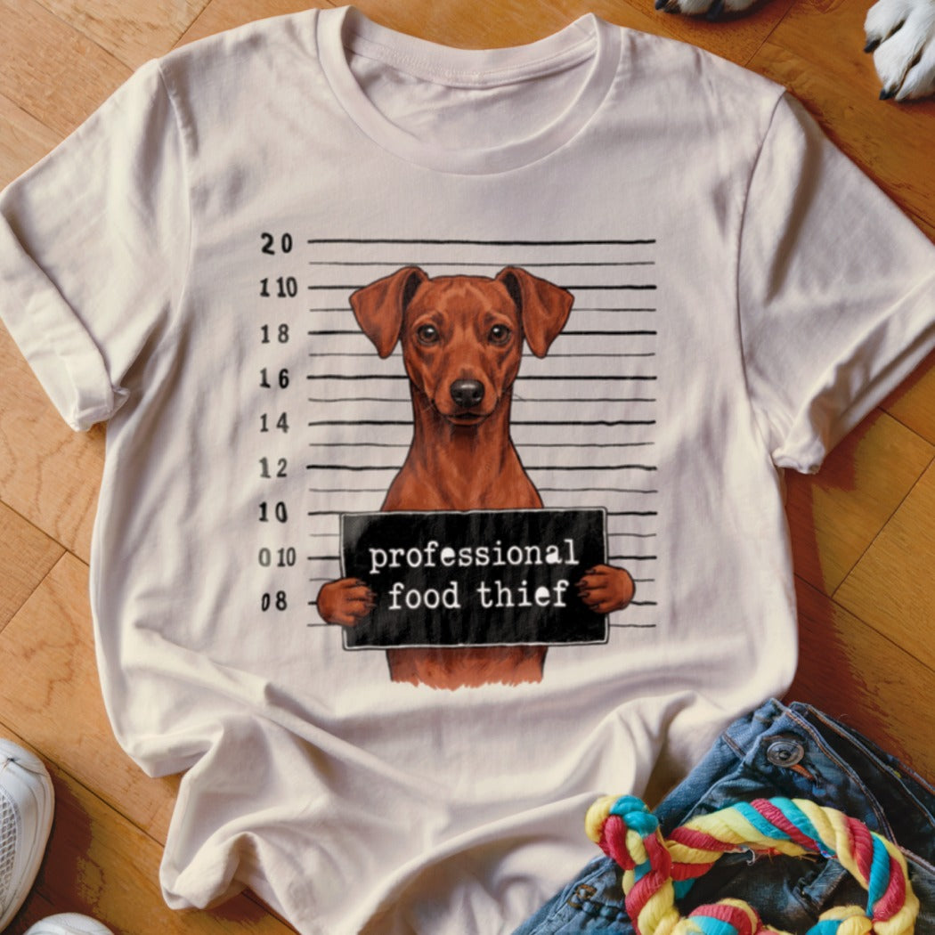 White t-shirt with a dog mugshot graphic reading "professional food thief".