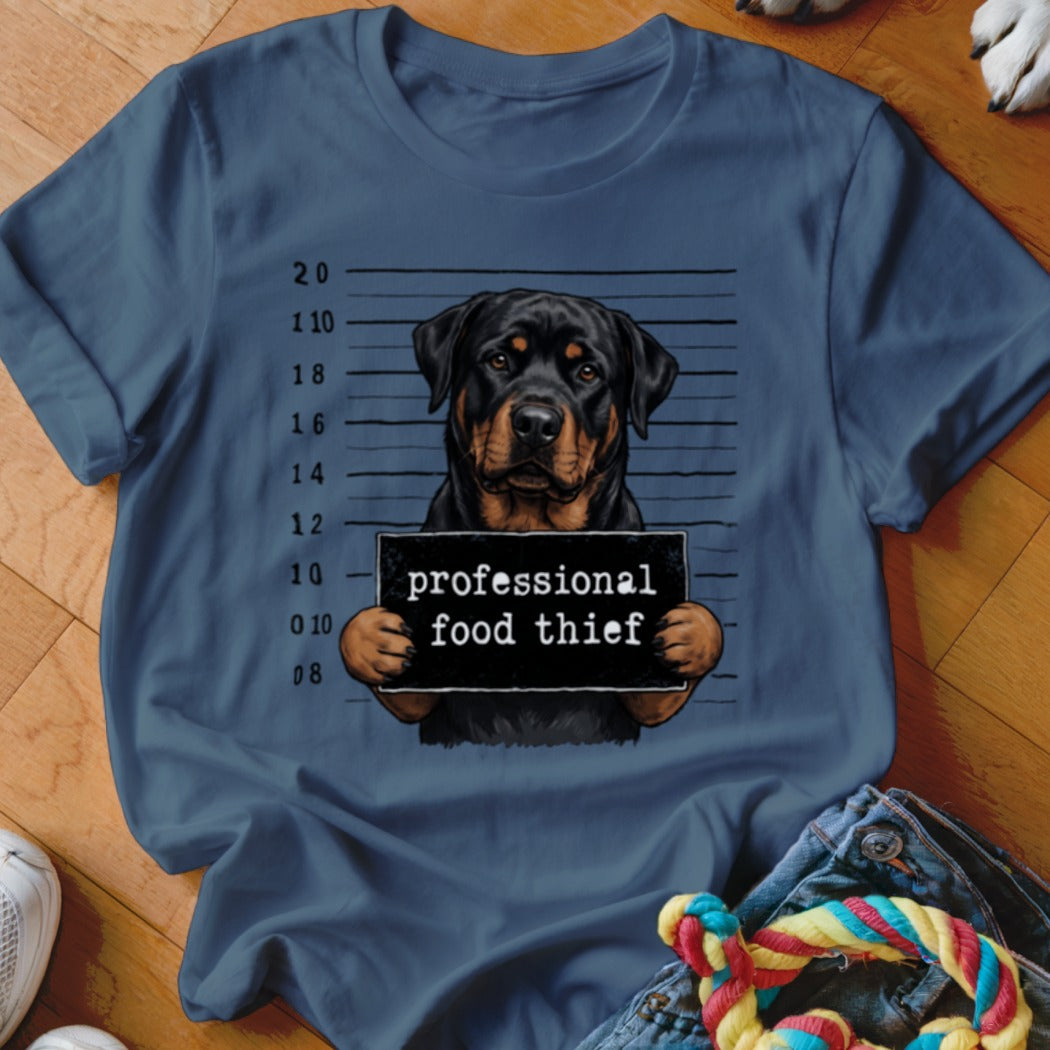 Rottweiler mugshot with sign reading "professional food thief".