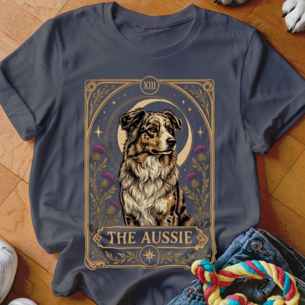 A dark grey crewneck t-shirt featuring a tarot card graphic of an Australian Shepherd with the text The Aussie.