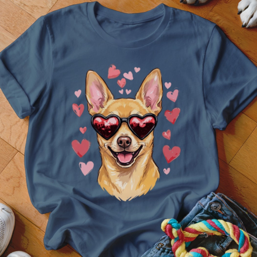 A slate blue t-shirt printed with a smiling tan Chihuahua wearing heart-shaped sunglasses, surrounded by pink hearts.