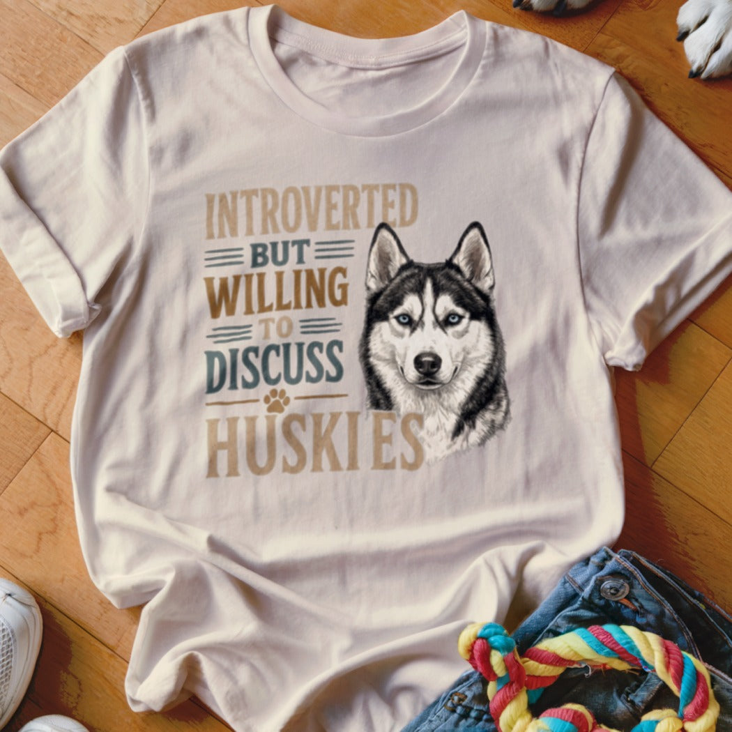 White t-shirt with a husky illustration and text that reads "INTROVERTED BUT WILLING TO DISCUSS HUSKIES".