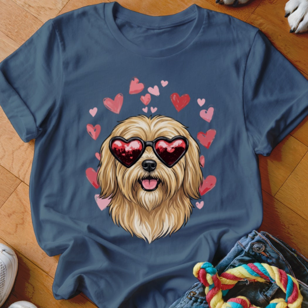 A navy blue t-shirt printed with a graphic of a shaggy blonde dog wearing heart sunglasses surrounded by floating pink hearts.