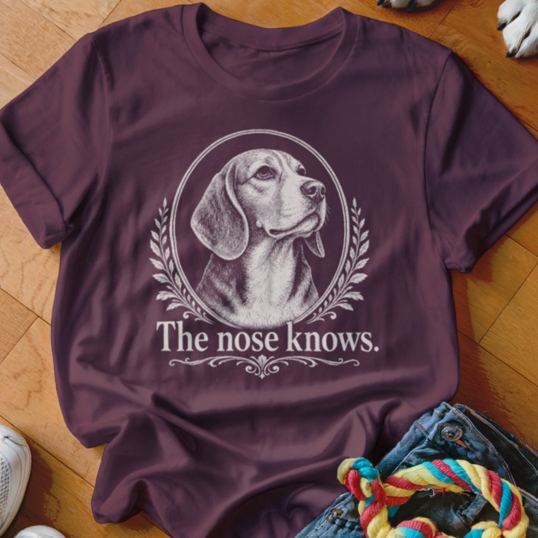 Burgundy t-shirt with Beagle portrait in a laurel wreath and text "The nose knows."