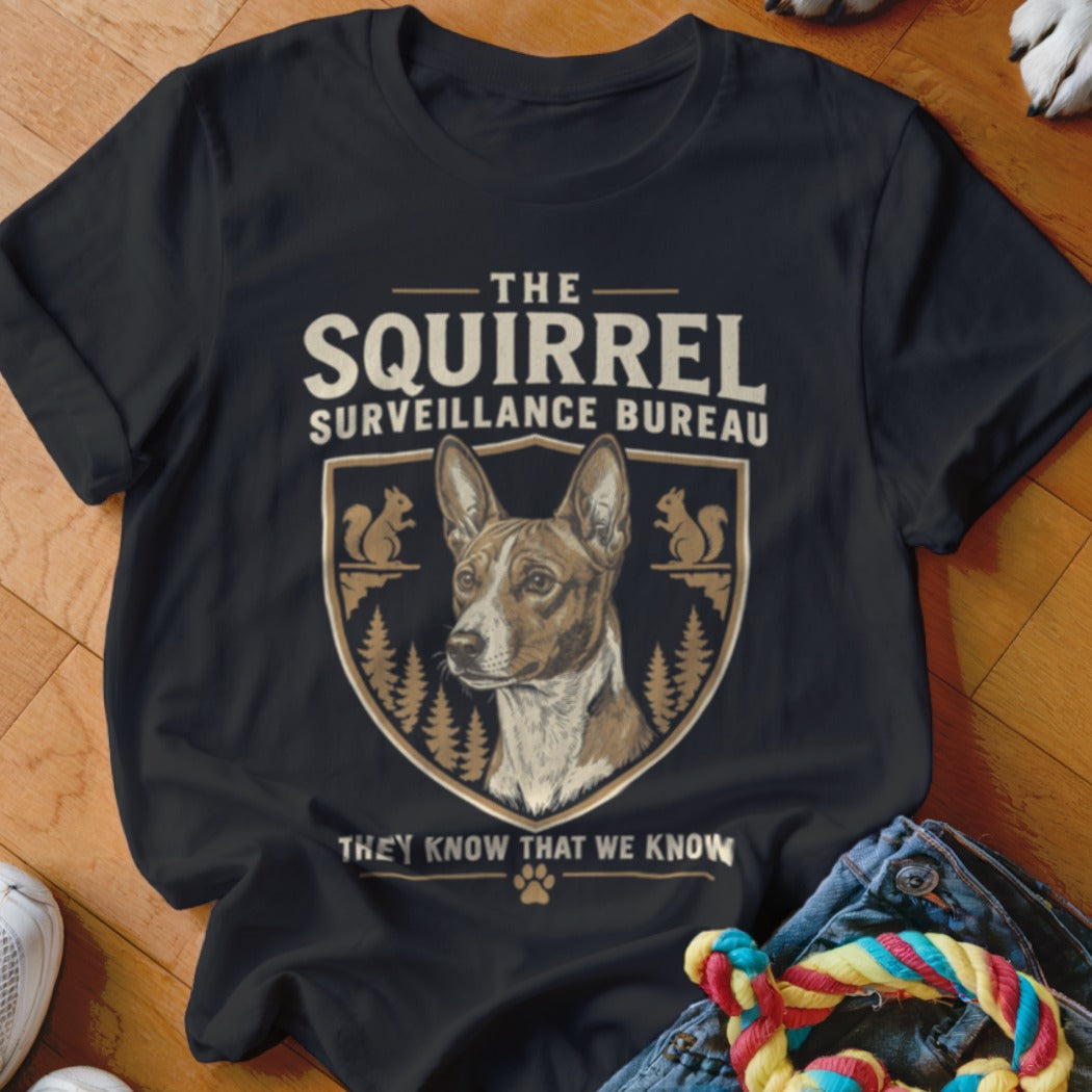 Black t-shirt featuring a graphic of a Basenji dog inside a crest with squirrel illustrations and text.