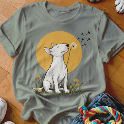 Sage green t-shirt featuring a graphic of a white bull terrier blowing a dandelion.