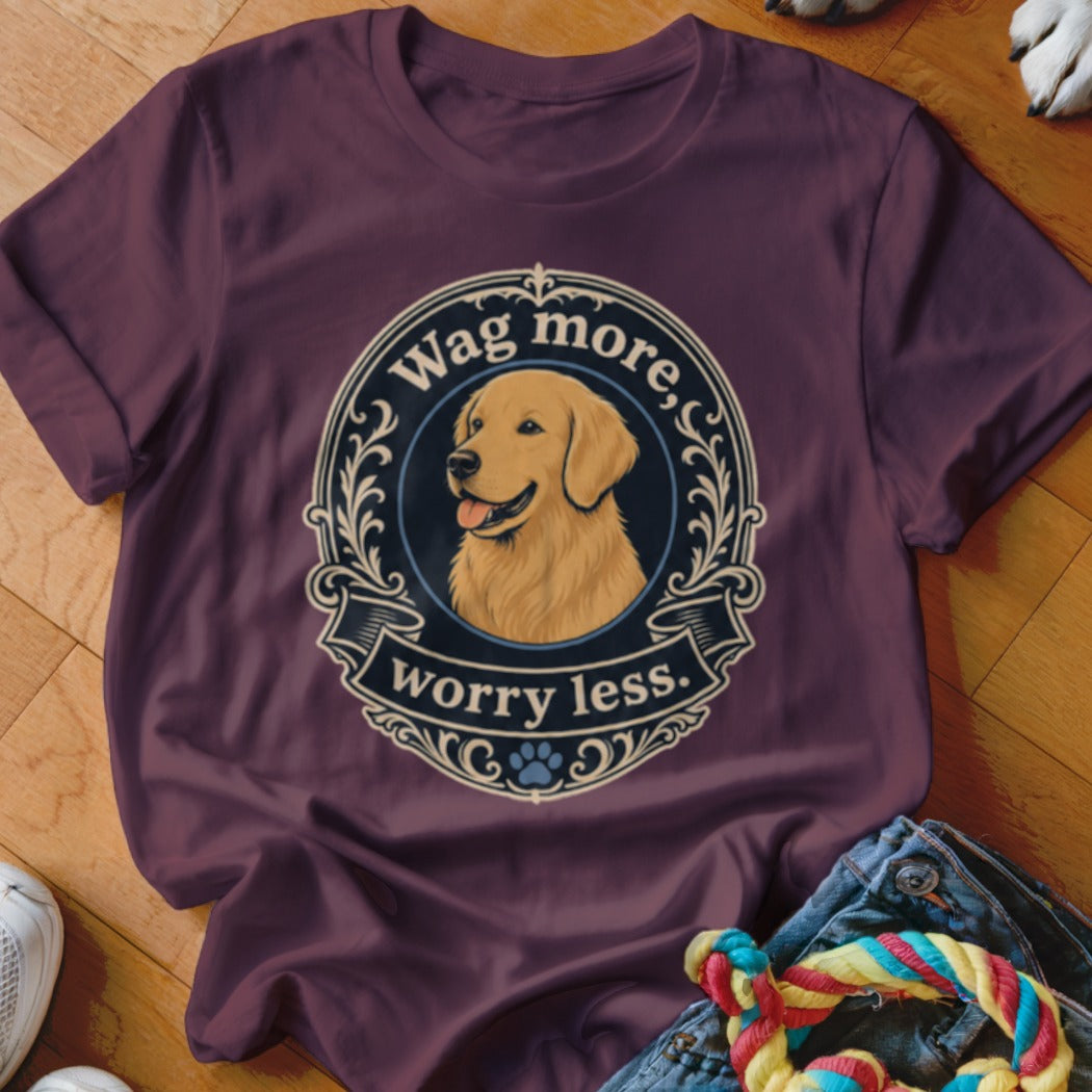 Golden Retriever illustration with text "Wag more, worry less." on a maroon t-shirt.
