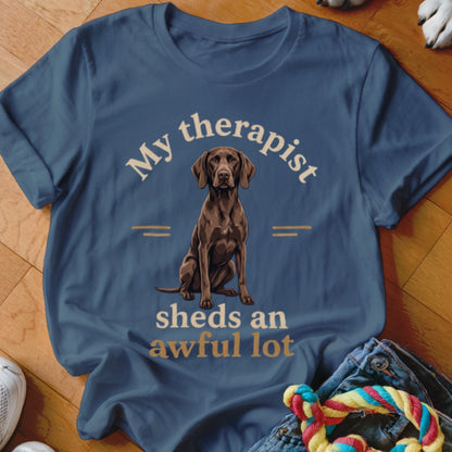 Blue t-shirt with a seated brown dog and text "My therapist sheds an awful lot."
