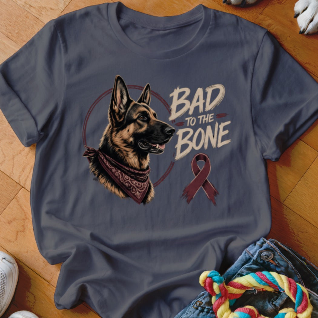German Shepherd wearing bandana with text "BAD TO THE BONE" and a ribbon.