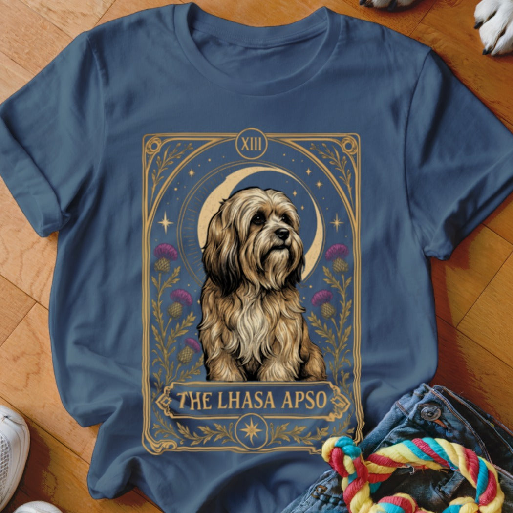 A dark blue t-shirt displays a tarot-style graphic of a Lhasa Apso dog with thistles, a crescent moon, and the text "THE LHASA APSO".
