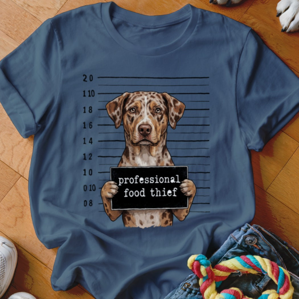 Dog mugshot with sign reading "professional food thief."