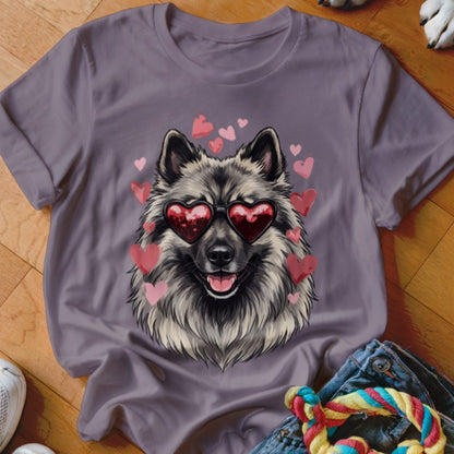 A gray t-shirt featuring a fluffy Keeshond dog wearing red heart-shaped sunglasses surrounded by floating pink hearts.