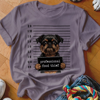 T-shirt graphic of a Brussels Griffon mugshot with "professional food thief" sign.