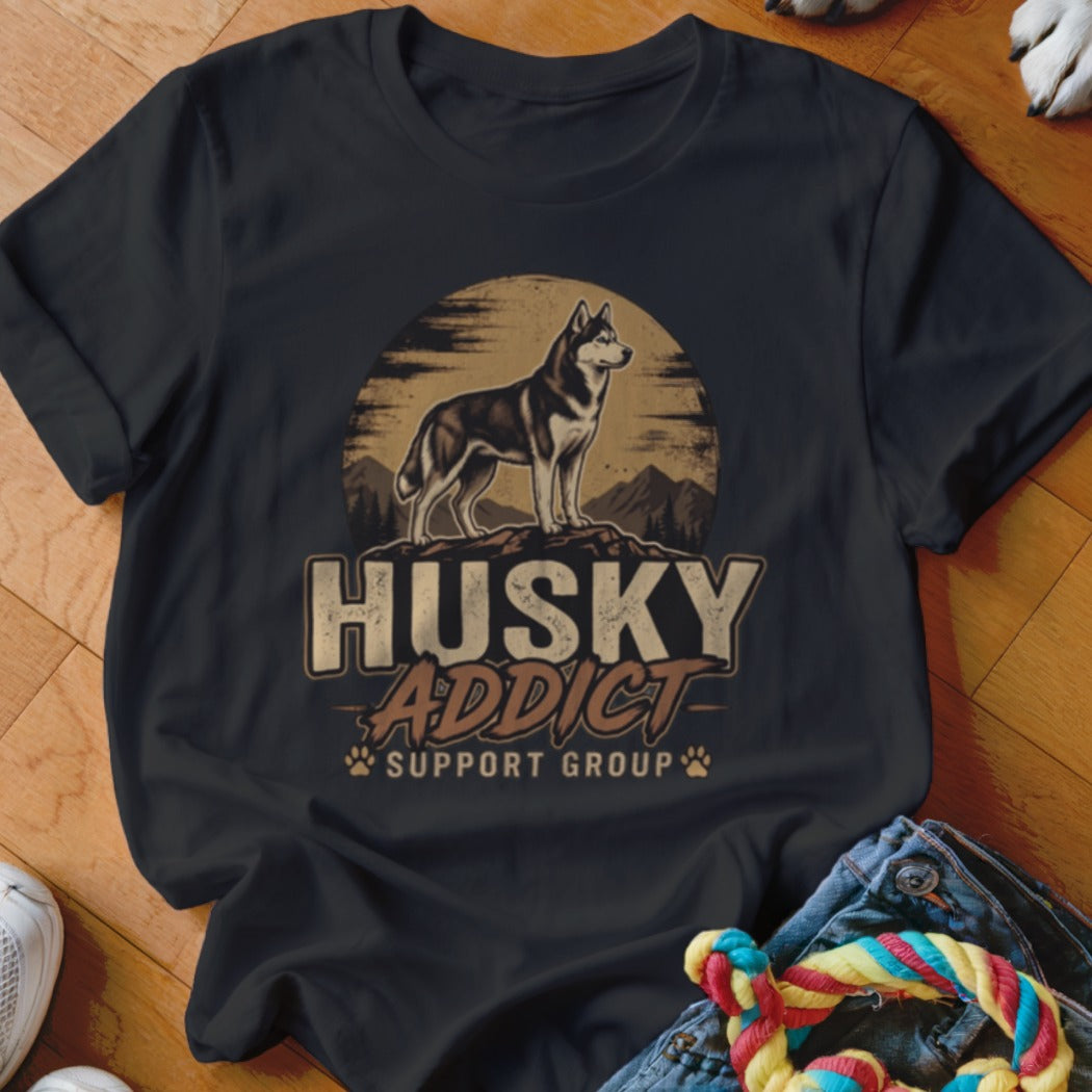 A black t-shirt printed with a husky graphic and the text HUSKY ADDICT SUPPORT GROUP.