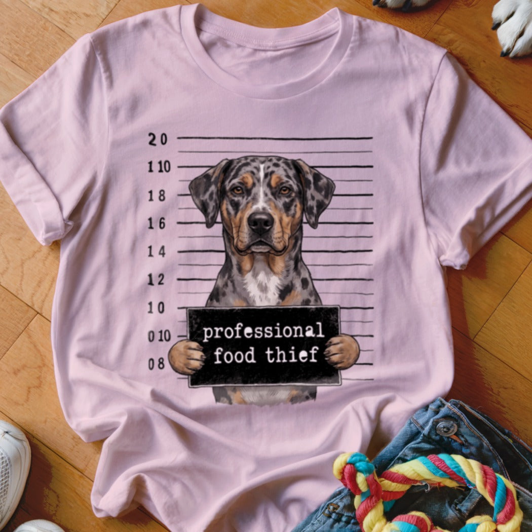 Light pink t-shirt with a dog mugshot graphic reading "professional food thief".