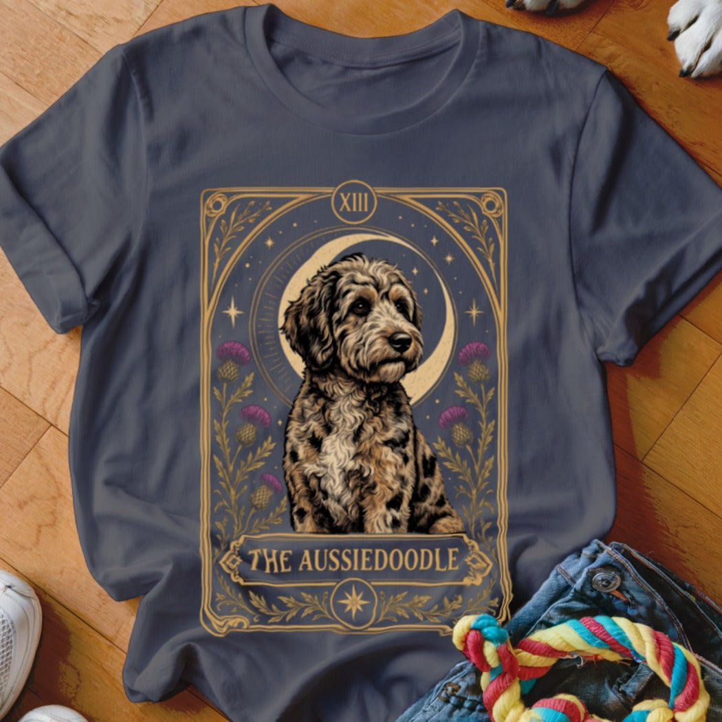 Charcoal t-shirt featuring a tarot card style illustration of an Aussiedoodle with purple flowers and a crescent moon.