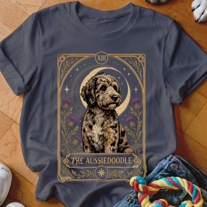 Charcoal t-shirt featuring a tarot card style illustration of an Aussiedoodle with purple flowers and a crescent moon.
