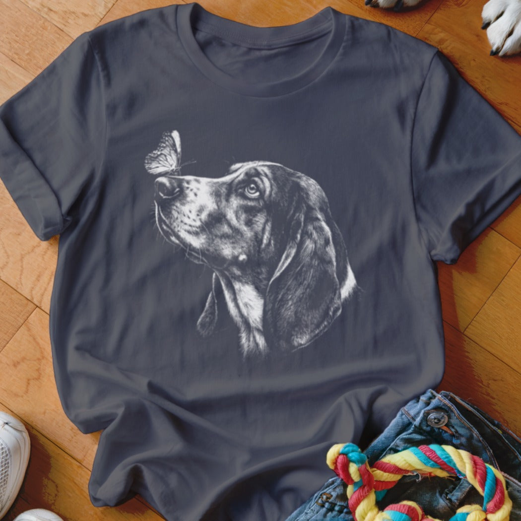 Dark grey t-shirt featuring a white sketch graphic of a hound dog with a butterfly on its nose.
