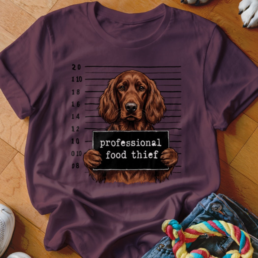 Brown dog mugshot with text "professional food thief" on a dark t-shirt.